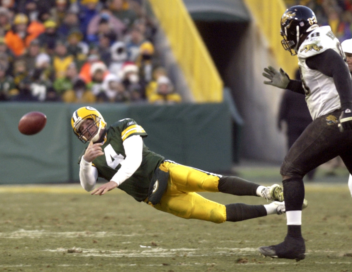 Lambeau Field - 12-19-04 - Brett Favre tosses the ball out of bounds to avoid a sack in the second quarter against Jacksonville at Lambeau Field, Green Bay, Sunday December 19, 2004.  Oshkosh Northwestern photo by Joe Sienkiewicz   Oshkosh Northwestern photo by Joe Sienkiewicz