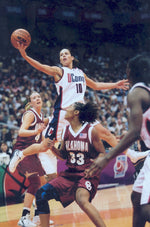 Sue Bird drives between a pair of Oklahoma defenders during the 2002 NCAA championship game in San Antonio. UConn Photo