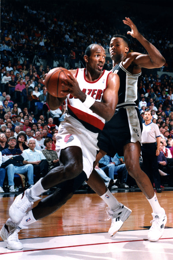 Portland Trail Blazers Clyde Drexler (left) drives in a home game against the San Antonio Spurs in May of 1993. Photo by Joel Davis/The Oregonian