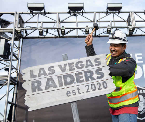 Allegiant Stadium worker Apollo Corley drives a stake into a ceremonial Las Vegas Raiders sign during the franchise’s official naming ceremony on Jan. 22, 2020. Benjamin Hager/Las Vegas Review-Journal