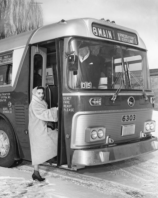 Miss Tosca Biscaro demonstrates low-level steps on one of the newly purchased buses by Niagara Frontier Transit Company in December 1958. Courtesy Buffalo News Archives