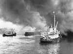 A Coast Guard cutter assists in fighting a blaze at the foot of Michigan Street on Sept. 21, 1953. Courtesy Buffalo News Archives