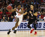 Virginia's guard De'Andre Hunter (12) drives against Jose Perez (5) in the first half against Gardner-Webb in the first round of the men's NCAA Tournament at Colonial Life Arena. Virginia went into the half with a six-point deficit. Courtesy Zack Wajsgras/The Daily Progress