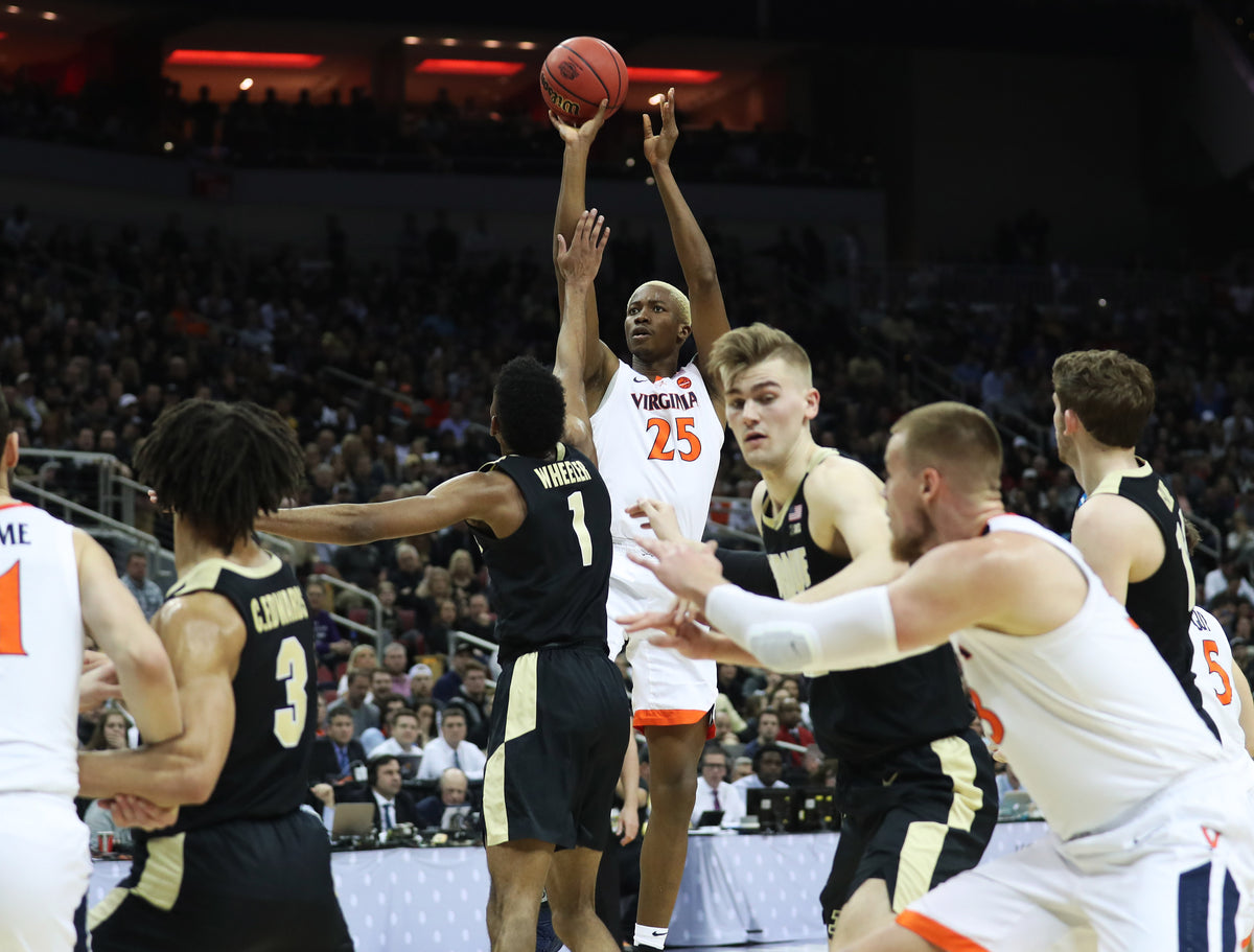 Virginia forward Mamadi Diakite (25) takes a deep shot in the first half at the KFC Yum! Center on Saturday. Virginia went into the half behind 30-29. ZACK WAJSGRAS/THE DAILY PROGRESS