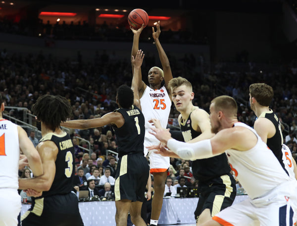 Virginia forward Mamadi Diakite (25) takes a deep shot in the first half at the KFC Yum! Center on Saturday. Virginia went into the half behind 30-29. ZACK WAJSGRAS/THE DAILY PROGRESS
