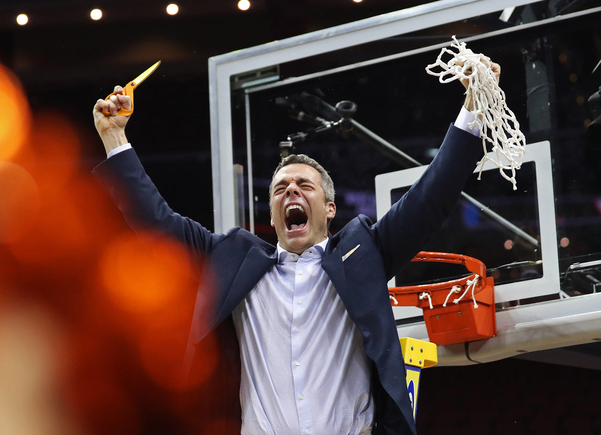 Coach Tony Bennett celebrates Virginia's Final Four win after cutting down the net. ZACK WAJSGRAS/THE DAILY PROGRESS ^^ center light rgba(10,10,10,0.35)
