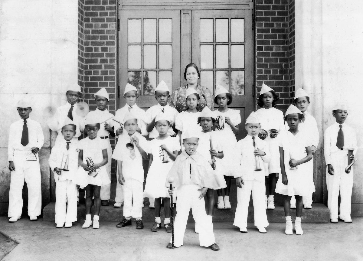 Culpeper Training School music teacher Mary Landonia Lightfoot Barbour Tansimore Greenwood poses with her band students, 1933. A Culpeper native born to merchant J. E. R. Lightfoot and his wife, Martha Pauline Childs, Greenwood (1902–1967) began teaching in Culpeper about 1929. Known throughout the region for her musical ability, she also directed a community choir. Courtesy Carver 4-County Museum