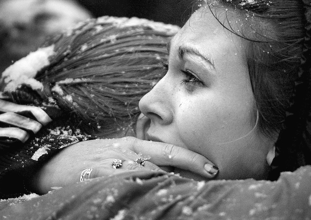 Mourners comforting each other during the funeral of Matthew Shepard near downtown Casper on Oct. 16, 1998. Casper Star-Tribune