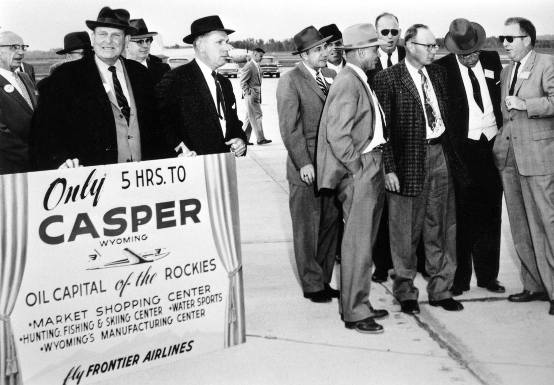 Airport Board President Milt Coffman holding a Casper promotional board while celebrating the arrival of Frontier Airlines to Natrona County International Airport, 1958. Courtesy Casper College Western History Center