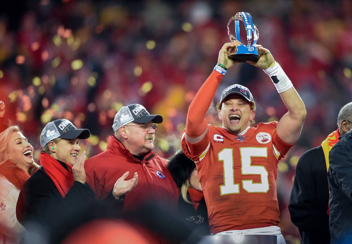 From left, Tavia and Clark Hunt, Chiefs owner, Chiefs coach Andy Reid look on as quarterback Patrick Mahomes hoists the Lamar Hunt Trophy after the Chiefs captured the AFC Championship after defeating the Tennessee Titans, 35-24, Sunday, Jan. 19, 2020, at Arrowhead Stadium in Kansas City. TAMMY LJUNGBLAD / KANSAS CITY STAR