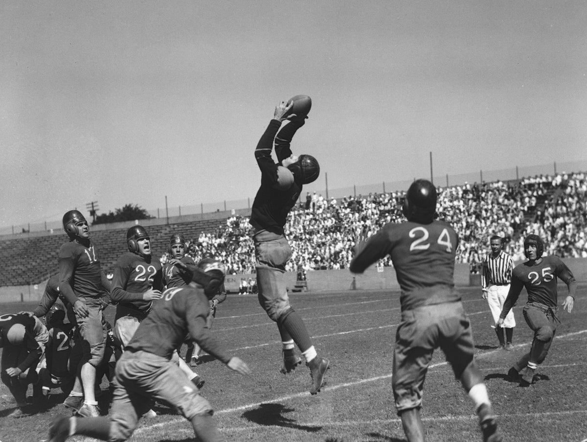 The All-Ohio football team from Canton and Akron beat Cleveland's star players 13-17 at Shaw High School Stadium, 1935. Lundblad, of Celveland, taking a pass from Brooks for the first touchdown in the first quarter. Courtesy Cleveland Public Library