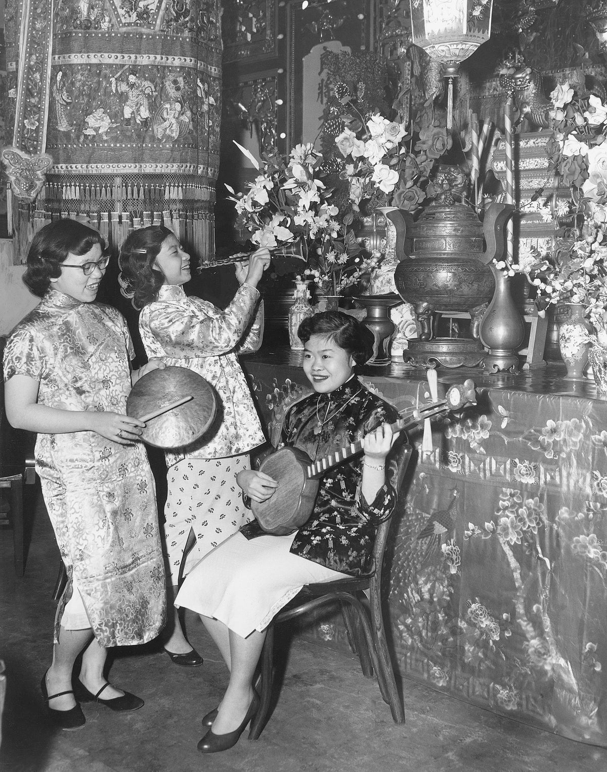 Tuning up for the Chinese New Year in 1955 are, from left, Wanda Louie, Dorothy Chan, and Lotus Chan. Courtesy Cleveland Public Library Photograph Collection/#SCL012236