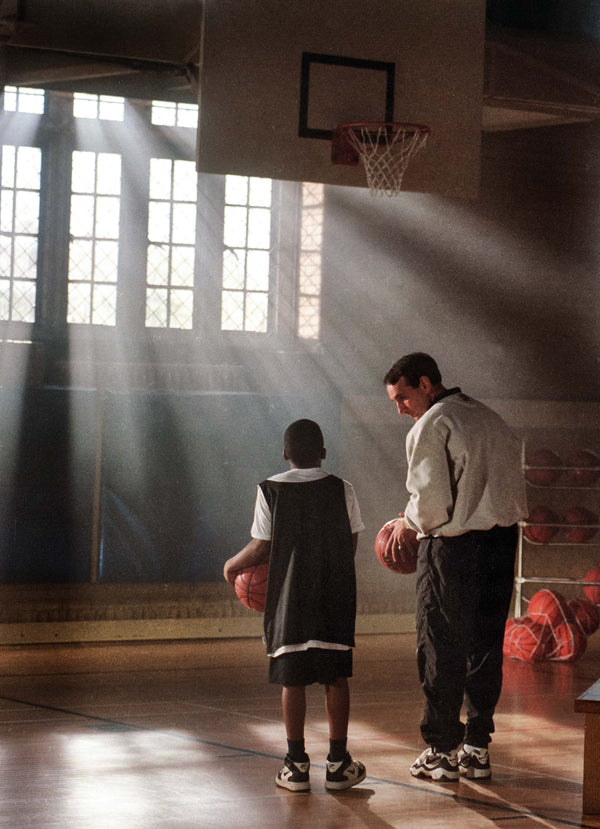 Knightdale's Travis Williams, 10, gets a little instruction from Duke head coach Mike Krzyzewski in Card Gym Monday morning as they filmed an ad spot for the American Cancer Society, Dec. 15, 1997. Chuck Liddy/The News & Observer