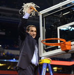 Duke head coach Mike Krzyzewski celebrates after cutting down the net after Duke's 68-63 victory over Wisconsin in the 2015 Division I Men's Basketball Championship game at Lucas Oil Stadium in Indianapolis, Ind., April 6, 2015. Chuck Liddy/The News & Observer