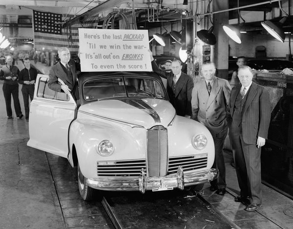 This 1942 Packard was the last car to come off the assembly line before the factory converted to manufacturing for the war effort. George Christopher is standing at right. Courtesy Detroit Public Library / #EB01e823