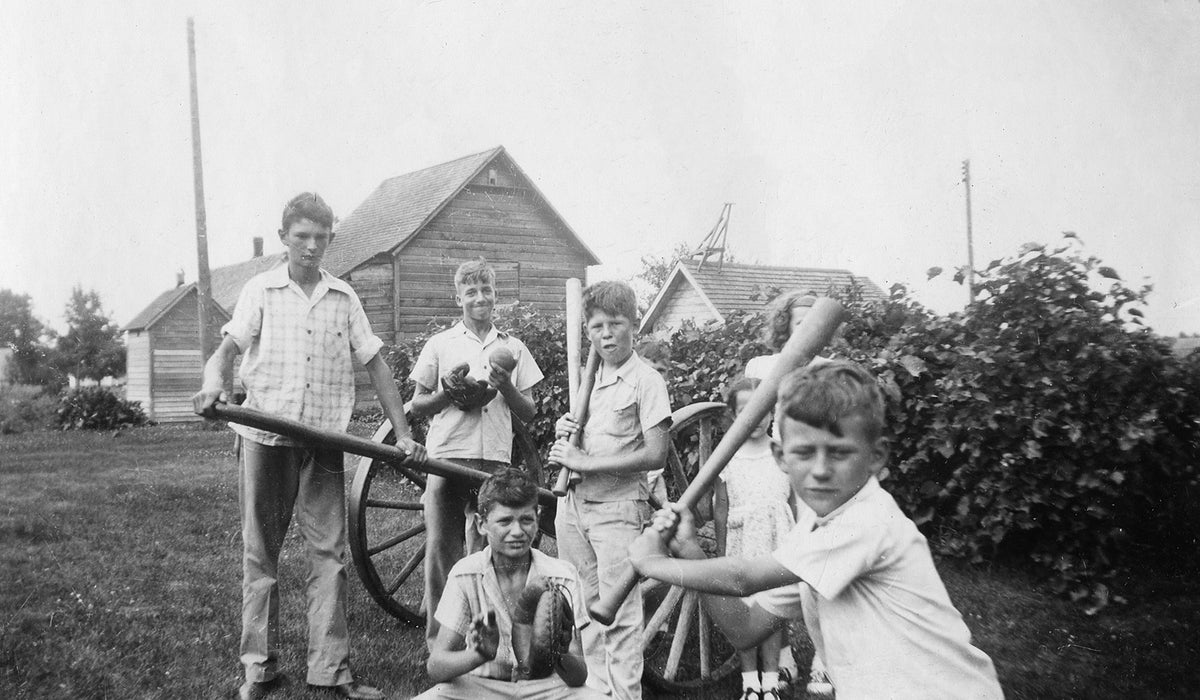 Five boys playing softball, with two girls looking on. Pictured from left are Herbert Poncin, Jerome Peters, David Poncin, Robert Norman, and Bruce Poncin, 1947. Courtesy Nicollet County Historical Society