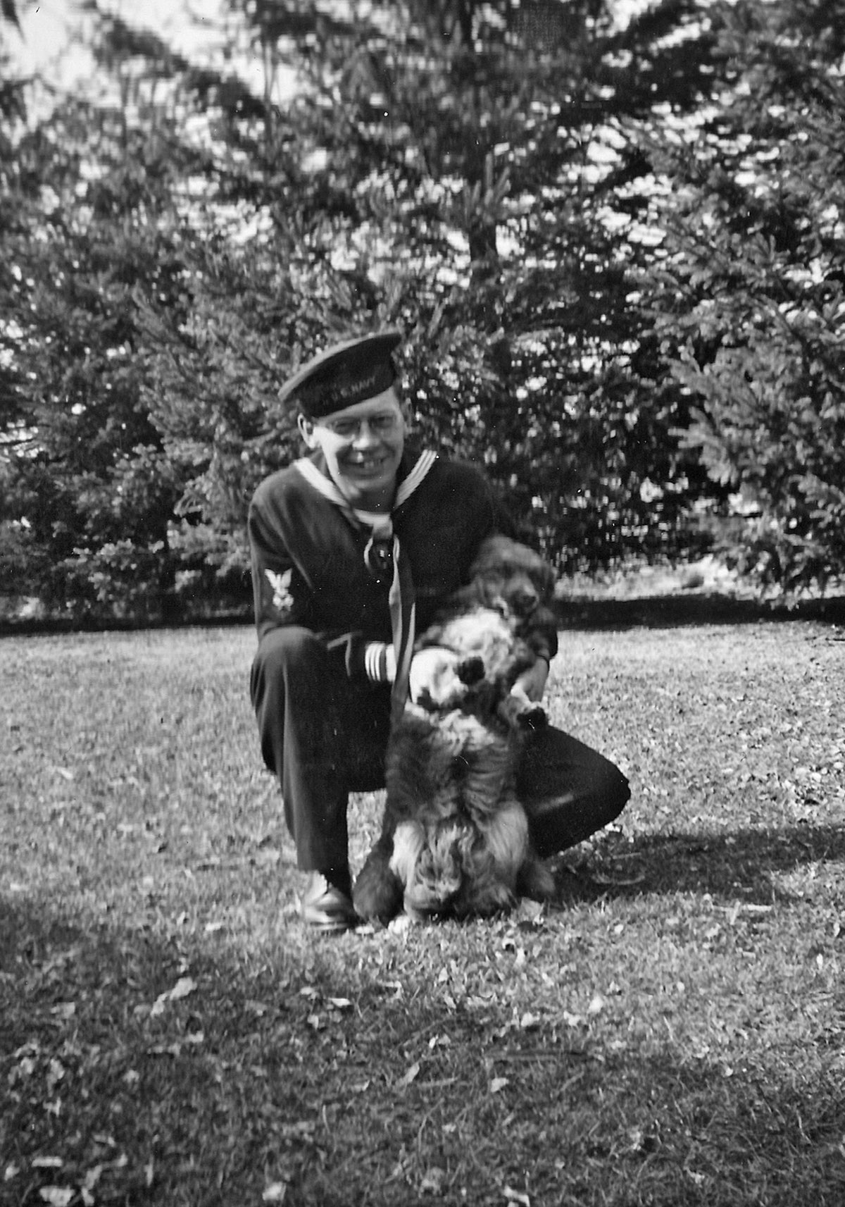 Martin Bode in his Navy dark blue uniform on a lawn with his dog, Pal, while home on leave in March 1943. Courtesy Nicollet County Historical Society