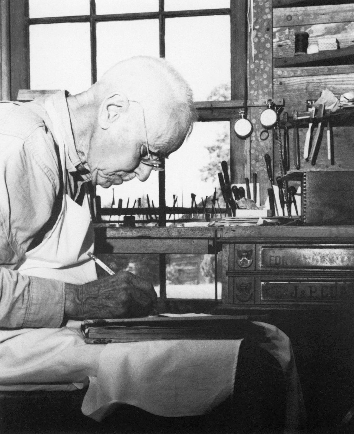 Calvin W. “Bud” Shaw inside his watch shop in Strieby (Pisgah), circa 1940. He was well known in the area for his expertise in repairing watches and clocks. Courtesy The Courier-Tribune