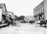 Men on horse-drawn carts overlooking a crowd of people on the street in Columbia, June 14, 1913. Courtesy Tyrrell County Public Library