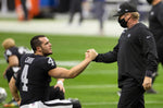 Raiders head coach Jon Gruden, right, greets Raiders quarterback Derek Carr (4) during warm ups before the start of an NFL football game against the Indianapolis Colts on Dec. 13, 2020, at Allegiant Stadium in Las Vegas. Benjamin Hager/Las Vegas Review-Journal