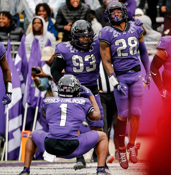 TCU defensive lineman George Ellis III (93), safety Millard Bradford (28) and cornerback Tre’Vius Hodges-Tomlinson (1) celebrates Bradford’s pick six as Hodges-Tomlinson imitates taking a picture in the first half of a NCAA football game at Amon G. Carter Stadium in Fort Worth, Texas, Saturday, Nov. 26, 2022. TCU led 34-7 at the half. (Special to the Star-Telegram / Bob Booth)