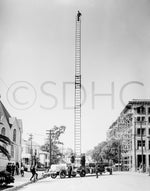 San Diego city firefighters demonstrate an 85-foot extension ladder on a $13,000 Seagraves fire truck, acquired in 1911. The truck also carried a searchlight, smoke helmet, 150-foot lifeline, and two life belts to lower unconscious people to safety. San Diego History Center (#3051)