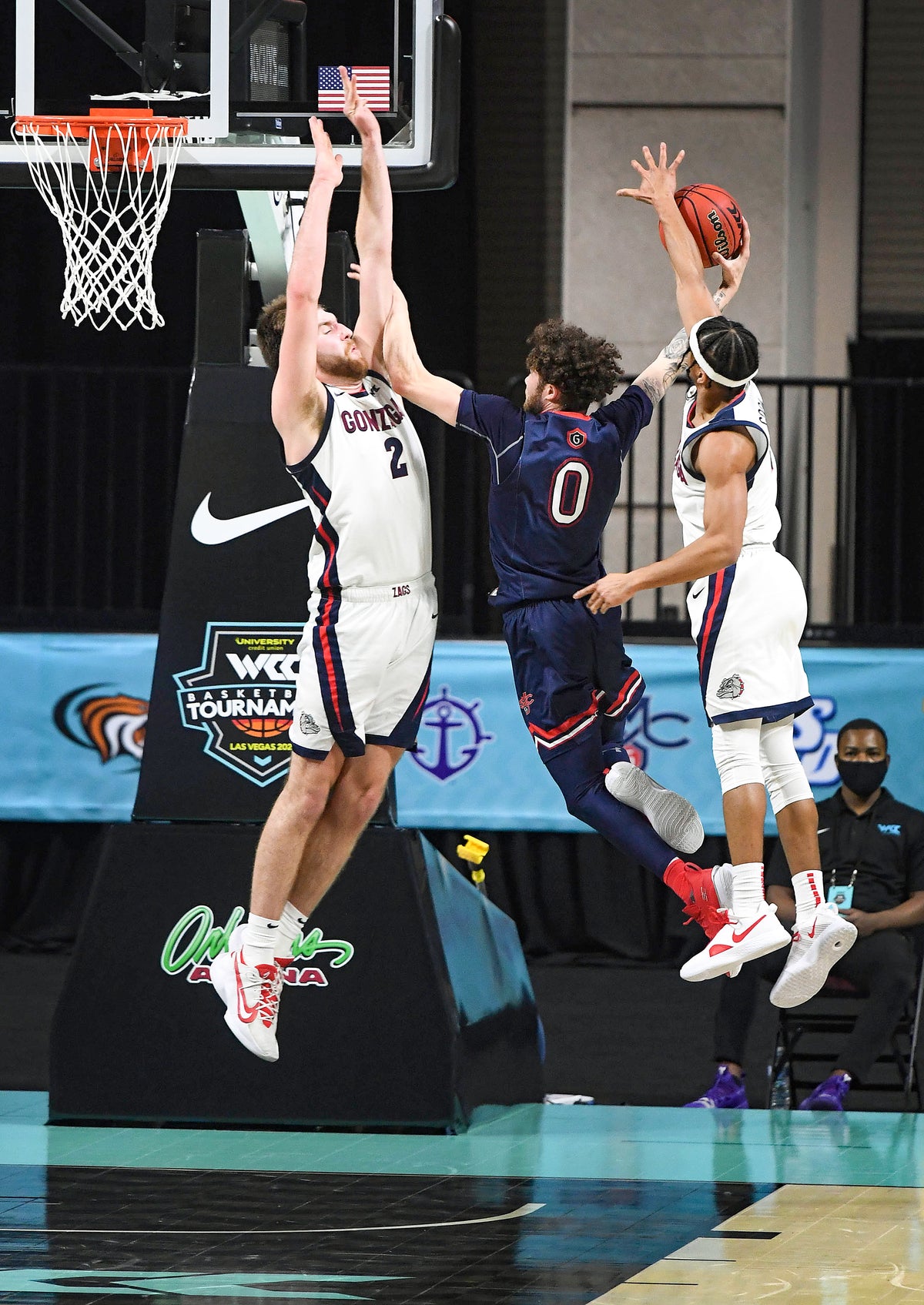 Gonzaga forward Drew Timme (2) and Gonzaga guard Aaron Cook (4) try to stop a shot by St. Mary's guard Logan Johnson (0), but Cook is called for a foul during the second half of a West Coast Conference semifinal NCAA college basketball game, March 8, 2021, at the Orleans Arena in Las Vegas. Colin Mulvany/The Spokesman-Review