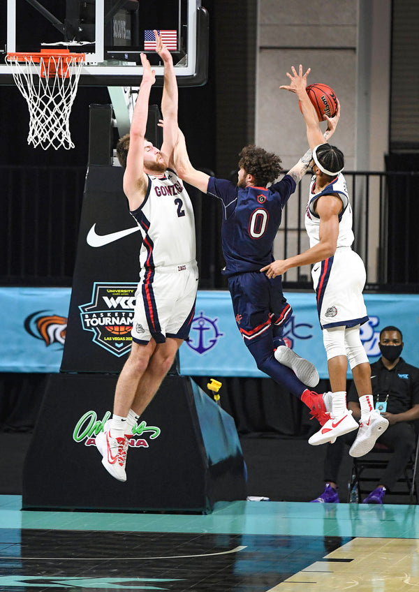 Gonzaga forward Drew Timme (2) and Gonzaga guard Aaron Cook (4) try to stop a shot by St. Mary's guard Logan Johnson (0), but Cook is called for a foul during the second half of a West Coast Conference semifinal NCAA college basketball game, March 8, 2021, at the Orleans Arena in Las Vegas. Colin Mulvany/The Spokesman-Review