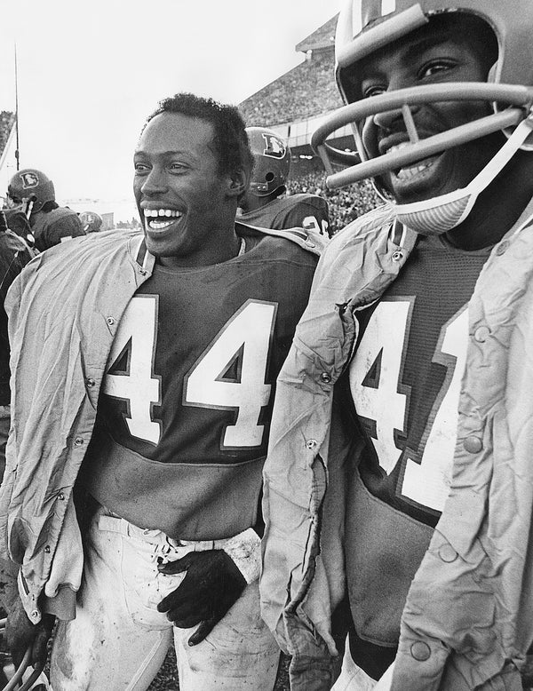 Denver Broncos Floyd Little (44) and his teammate Leroy Mitchell (41) celebrate on the sidelines as a touchdown is scored in the closing minutes of the fourth quarter of the season finale against New England, Dec. 17, 1972. The Broncos won 45–21. Barry Staver / The Denver Post