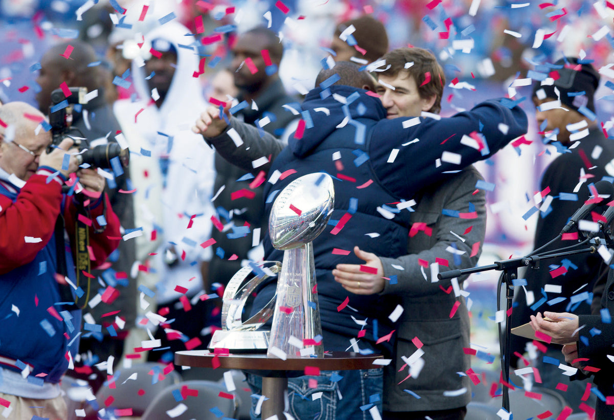Eli Manning gets a hug from a teammate at MetLife Stadium fan celebration. Courtesy Doug Hood/Asbury Park Press