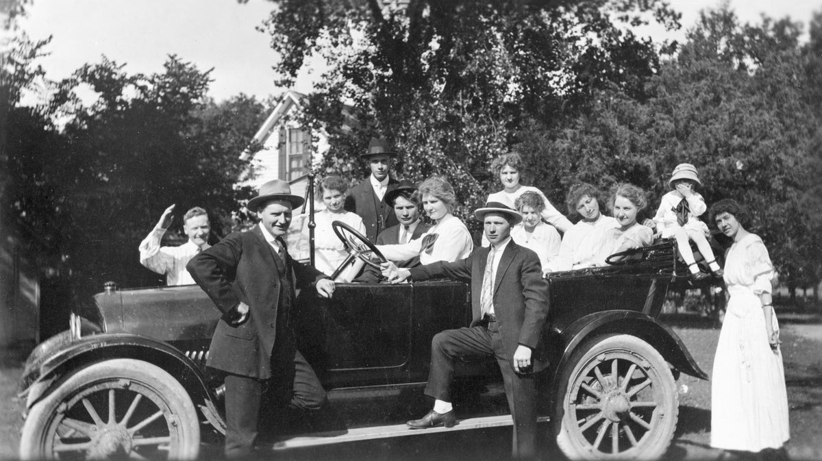 The Rosenkotter family on the family farm as they prepare for a Sunday afternoon drive in the country in a new 1916 Reo Touring Car, Grand Island. Pictured from left: Will, Carl Jr. (standing front left), Emma and her fiance Hugo Sommer, Henry, Marie (at wheel), Fred (standing front right), Anna, Martha, Emma (Thom), Ella, Milton, Hattie (Timmerman). The automobile belonged to Henry. Courtesy Deborah (Rosenkotter) Spaulding
