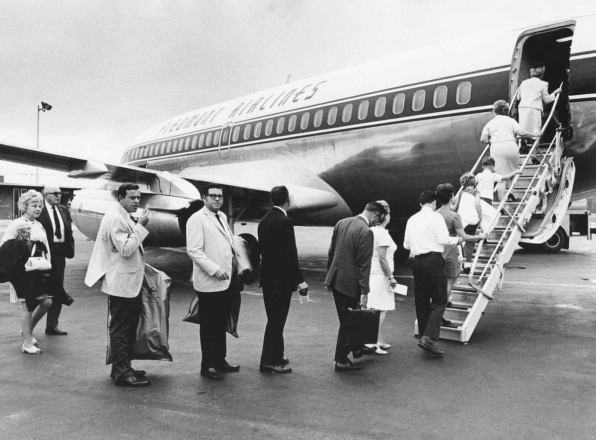 Eighteen people boarding Piedmont's first flight out after a strike, August 1969. Courtesy The News & Record