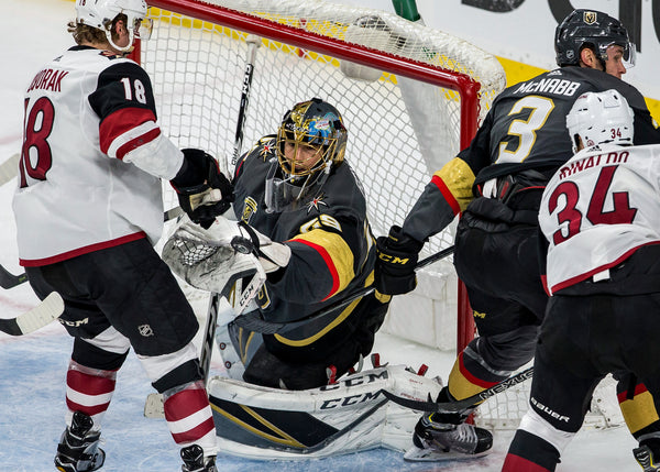 Golden Knights goaltender Marc-Andre Fleury (29) deflects the puck off his glove next to Arizona Coyotes center Christian Dvorak (18) during the second period of an NHL hockey game at T-Mobile Arena on Wednesday, March 28, 2018. Courtesy Patrick Connolly/Las Vegas Review-Journal