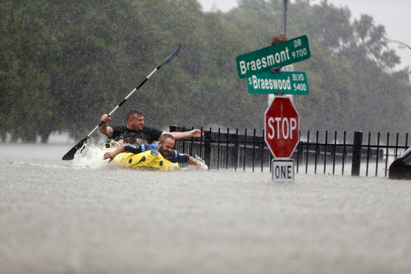 Two kayakers try to beat the current pushing them down an overflowing Brays Bayou along S. Braeswood in Houston, Texas, Sunday, Aug. 27, 2017. Courtesy Mark Mulligan / Houston Chronicle