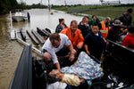 A rescuer moves Paulina Tamirano, 92, from a boat to a truck bed as people evacuate from the Savannah Estates neighborhood as Addicks Reservoir nears capacity Tuesday, Aug. 29, 2017 in Houston. Courtesy Michael Ciaglo / Houston Chronicle