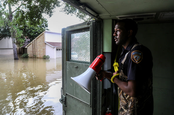 Harris County Sheriff's Deputy Rick Johnson pauses to listen for people's voices as they search for people in a neighborhood inundated by water from the Addicks Reservoir, Wednesday, Aug. 30, 2017, in Houston. Courtesy Jon Shapley  / Houston Chronicle
