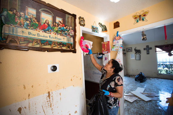 Alma Castenda pulls her children's artwork off the walls as she cleans up her flood damaged home in the Verde Forest subdivision in the aftermath of Tropical Storm Harvey on Thursday, Aug. 31, 2017, in Houston. Courtesy Brett Coomer / Houston Chronicle