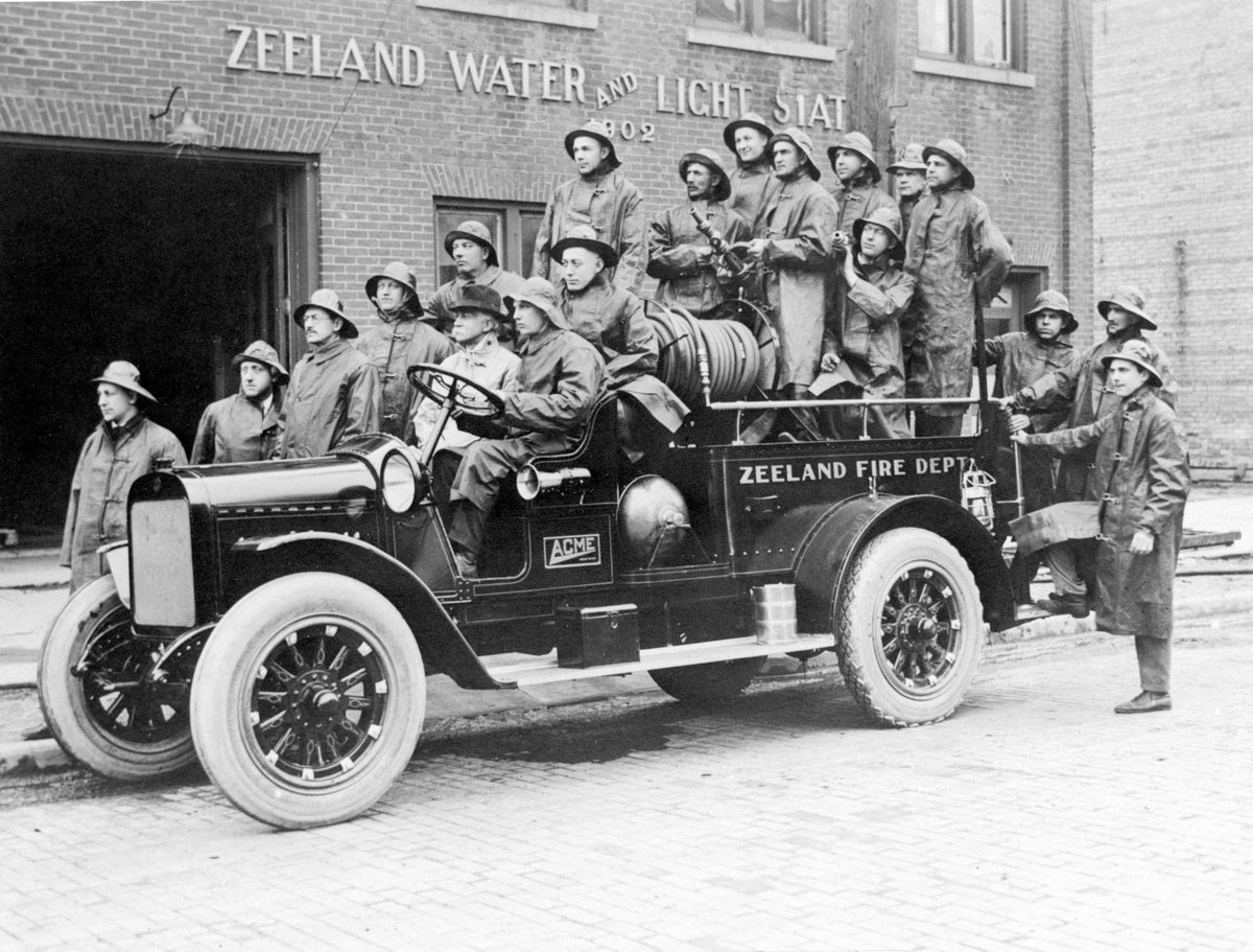 The Zeeland Fire Department on the city’s first fire truck, Elm Street, 1923. From left: William Wentzel, Dick Boonstra, M. C. VerHage, Flokke Wierda, Dr. William Heasley, Ed De Pree (driver), Jacob Meyboer, Dave Vereeke, Bert Van Loo, John Vereeke, George Vander Weide, William Hieftje, Gerrit Van Dyke, John Ver Hage, Gus Romeyn, Martin Korstanje, John Korstanje, Gerrit Heiftje, John Bouwens. Courtesy Patti Bing