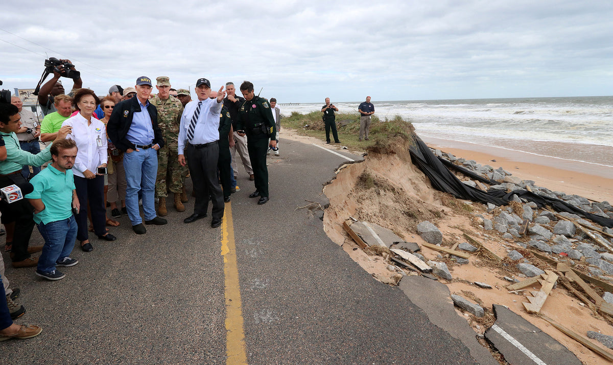 Florida Gov. Rick Scott, in jeans, and U.S. Rep. John Mica, gesturing, get a first-hand look at damage to State Road A1A in Flagler Beach. News-Journal/Jim Tiller