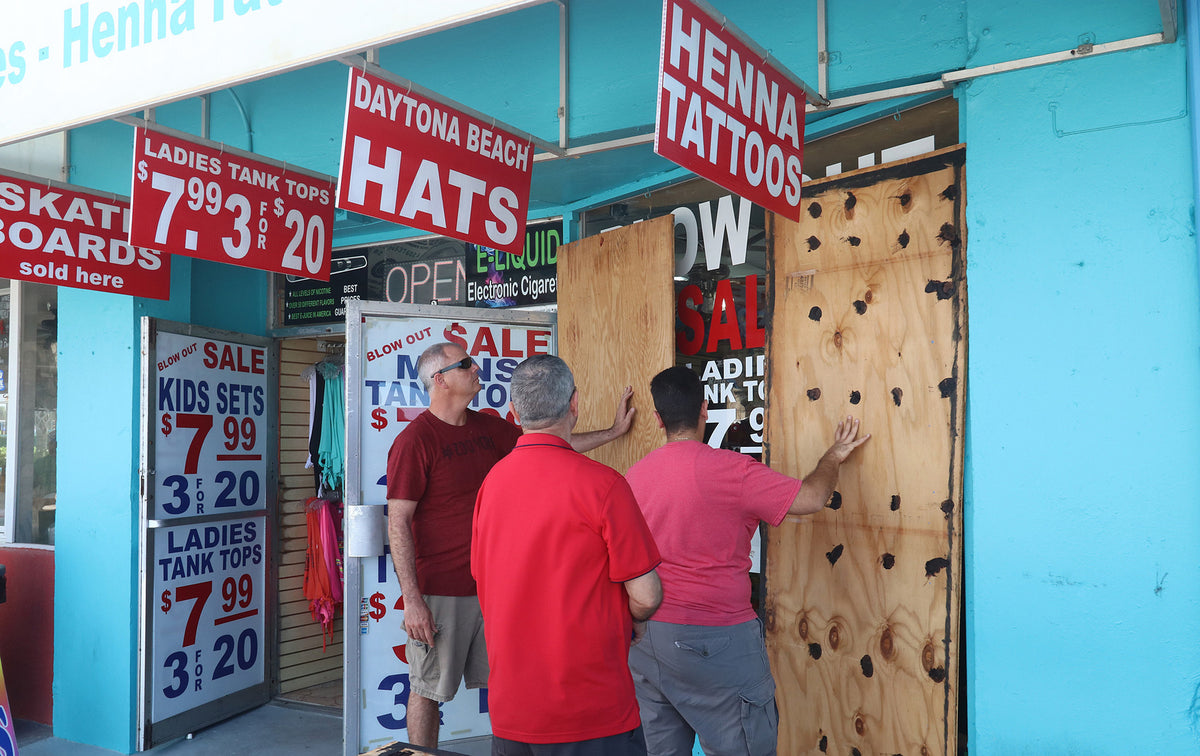 A shop owner puts plywood over windows along the Boardwalk in Daytona Beach. News-Journal/Jim Tiller