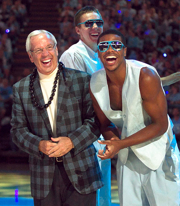 UNC head coach Roy Williams and Dexter Strickland laugh as Joe Holladay, director of basketball operations, shows off his dance moves during the annual Late Night With Roy kick-off to the basketball season on October 12, 2012, at the Smith Center in Chapel Hill, N.C. Courtesy Robert Willett / The News & Observer