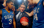 Duke head coach Mike Krzyzewski holds the game ball and is surrounded by players after he wins his 903rd career victory. Duke played Michigan State University at Madison Square Garden in New York City, Nov. 15, 2011. Chuck Liddy/The News & Observer