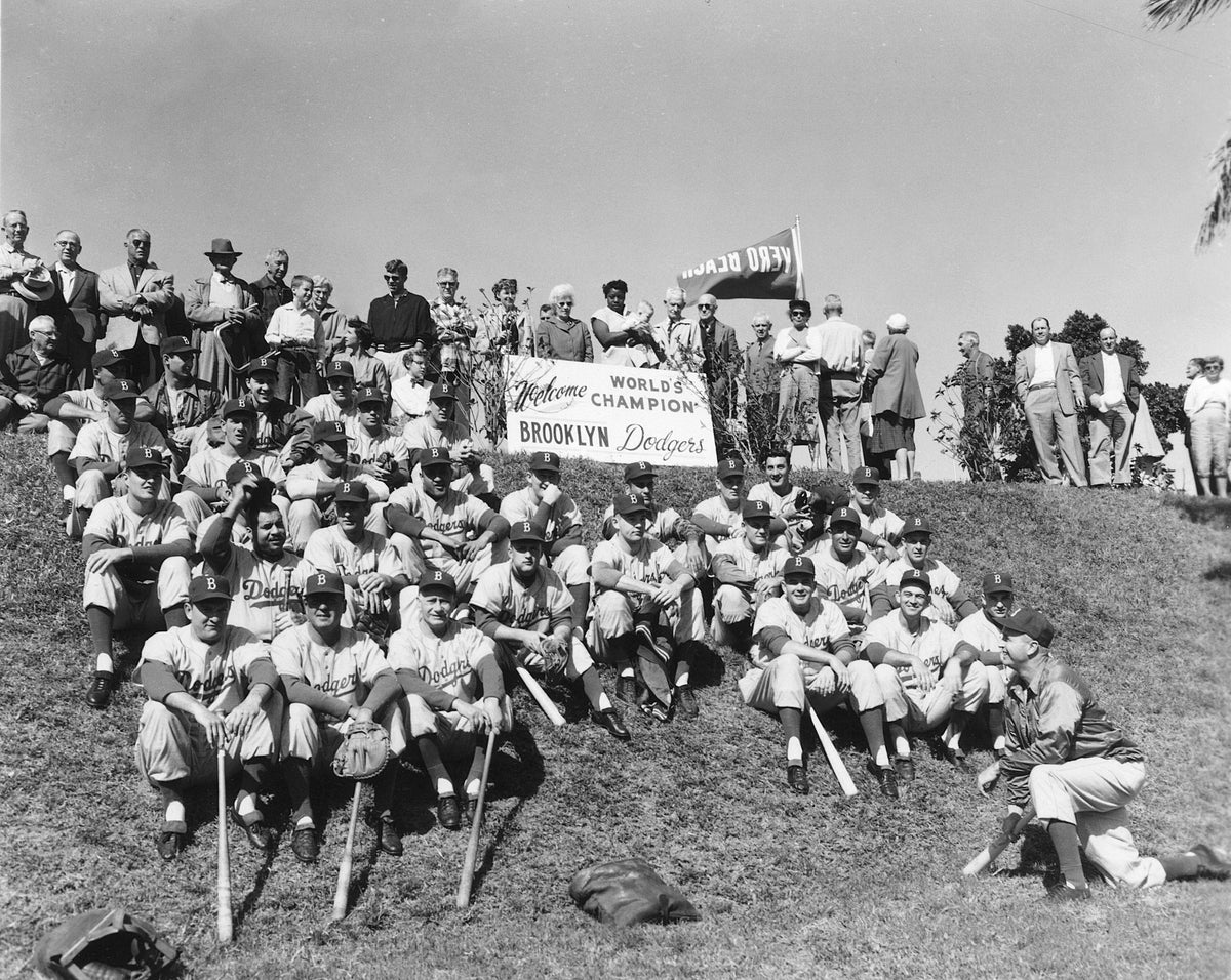 The Brooklyn Dodgers, winner of the 1955 World Series, sit on the berm at Holman Stadium in Vero Beach. Manager Walt Alston is kneeling on the bottom right. Courtesy Indian River County Historical Society Collection, Archive Center, Indian River County Main Library