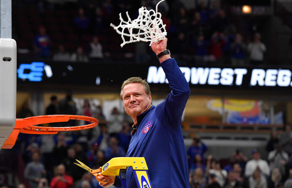 Kansas coach Bill Self takes the final snip of the net after his Jayhawks defeated Miami, 76-50, to win the NCAA Midwest Region Championship at the United Center in Chicago. Rich Sugg / The Kansas City Star