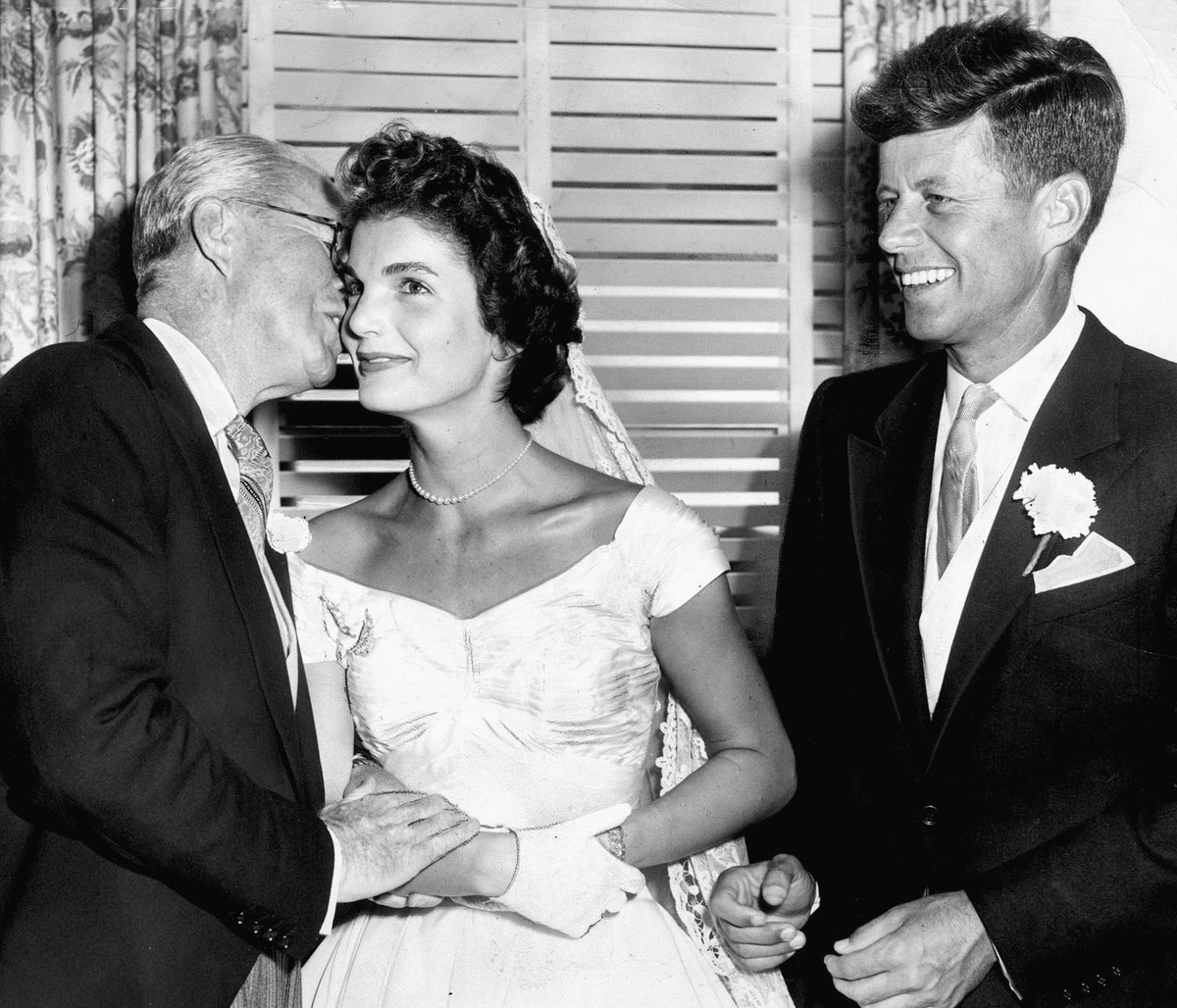 Joseph P. Kennedy kissing Jacqueline Bouvier Kennedy after her marriage to his son, Senator John F. Kennedy, in Newport, September 12, 1953. Courtesy The Providence Journal