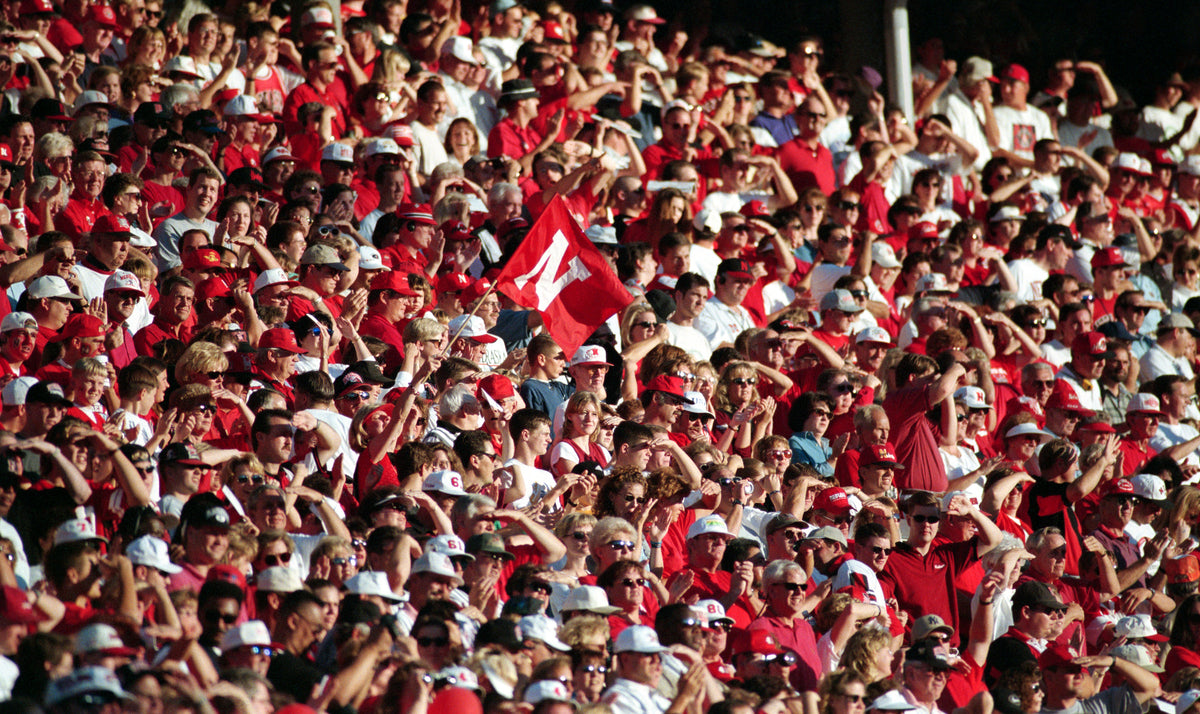 Husker defenders, including Grant Wistrom (98) and Jason Wiltz (99), ride a Wildcat to the ground. Nebraska held K-State to 260 yards of total offense. Courtesy Lincoln Journal Star