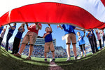 While holding an American flag in centerfield at Memorial Stadium, two children placed their hands over their hearts during the National Anthem.