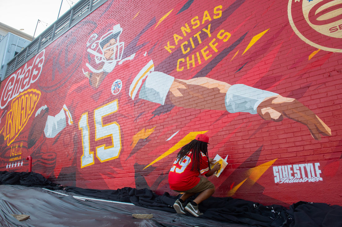 Mural artist Phil Shafer adds his finish touch on the new Patrick Mahomes mural at Westport Ale House in KC. The mural honors 60 years of Chiefs football in Kansas City.  Kansas City Star / Shelly Yang