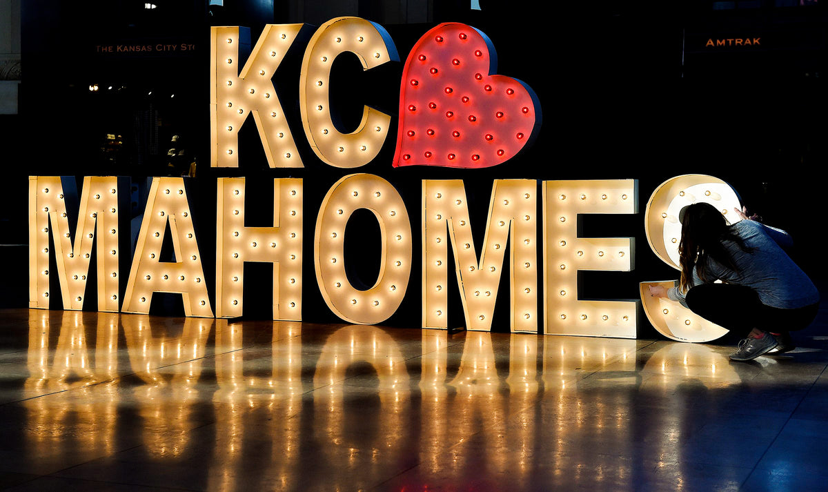 Lyndsey Coday of Alpha-Lit KC makes final adjustments to an electric Mahomes sign inside Kansas City’s iconic Union Station.  Kansas City Star / Jill Toyoshiba