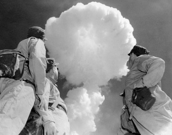 Three soldiers watch a rising mushroom cloud at the Nevada Test Site, circa 1952. From left, Chet Holifield, Sterling Cole and Melvin Price, members of the joint atomic committee.Courtesy National Atomic Testing Museum